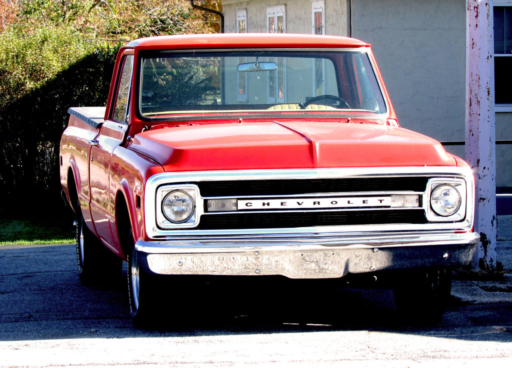 Old red Chevrolet truck in a parkinglot